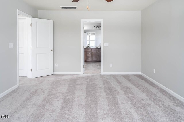 carpeted spare room with ceiling fan