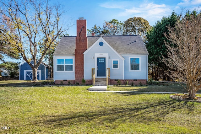 view of front facade with an outdoor structure and a front yard