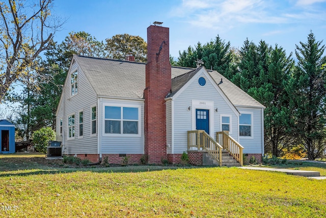 view of front facade with central AC and a front lawn