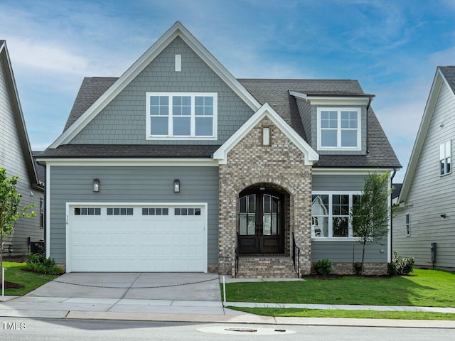 craftsman-style house with a front yard, french doors, and a garage