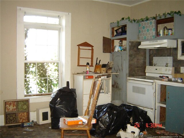 kitchen featuring a healthy amount of sunlight and white electric stove