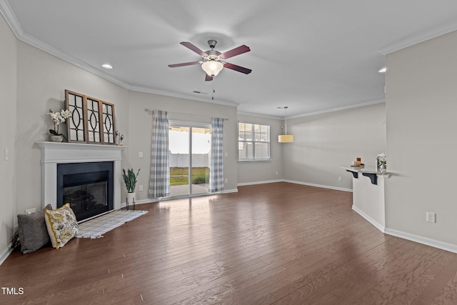 unfurnished living room with crown molding, ceiling fan, and dark wood-type flooring