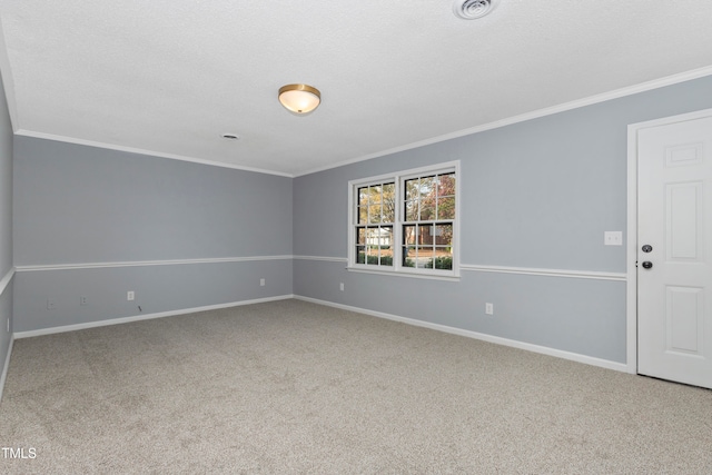 spare room featuring carpet, a textured ceiling, and ornamental molding