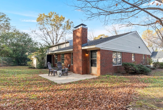 back of house with a yard and a patio