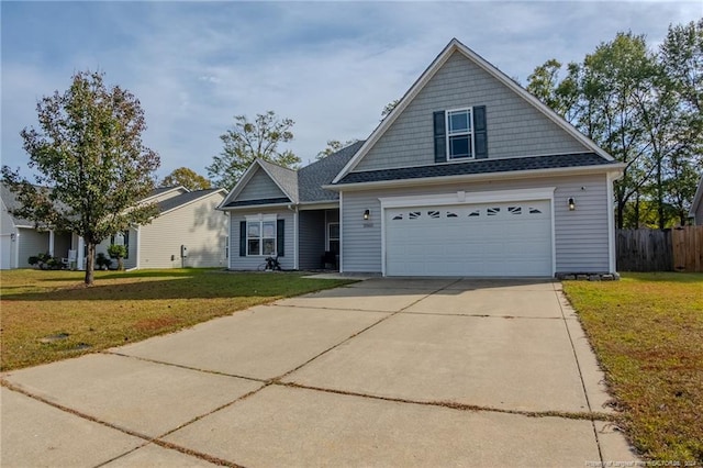 view of front of home with a garage and a front lawn