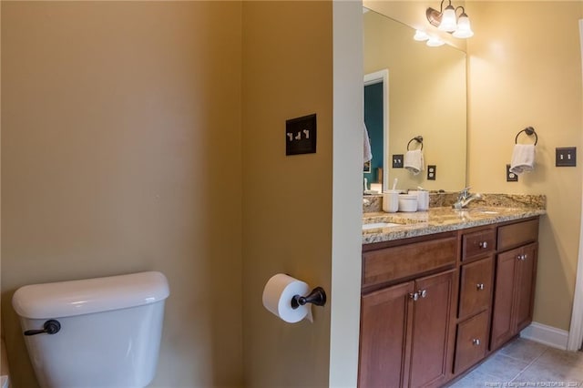 bathroom featuring tile patterned flooring, vanity, a notable chandelier, and toilet