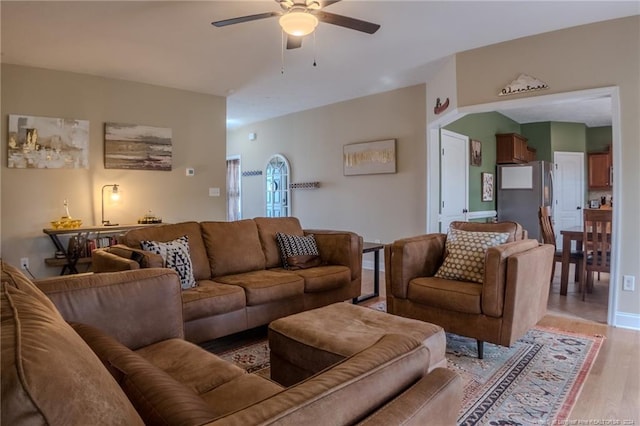 living room featuring light hardwood / wood-style floors and ceiling fan