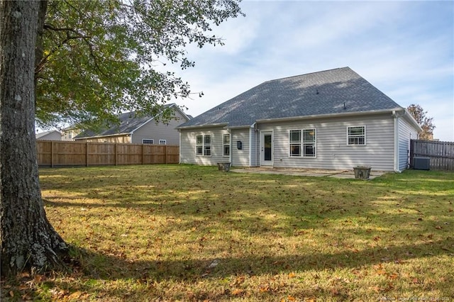 back of house featuring a yard and cooling unit