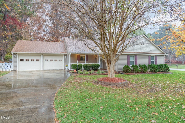 view of front of property with a porch, a front yard, and a garage