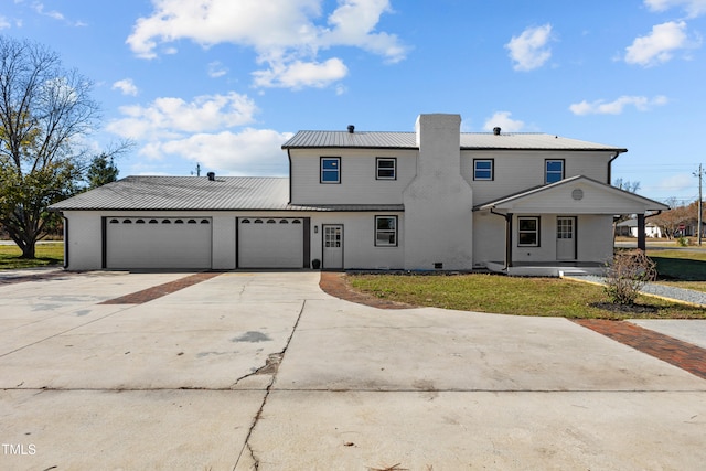 view of front of house with a garage and a front lawn