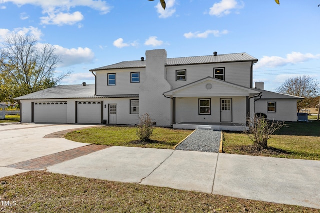 view of front of home with a garage, covered porch, and a front lawn