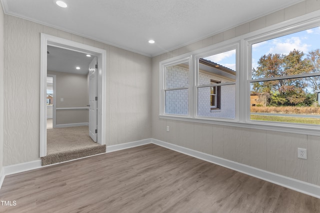 spare room featuring ornamental molding and wood-type flooring