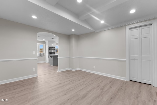 unfurnished room with lofted ceiling and light hardwood / wood-style floors