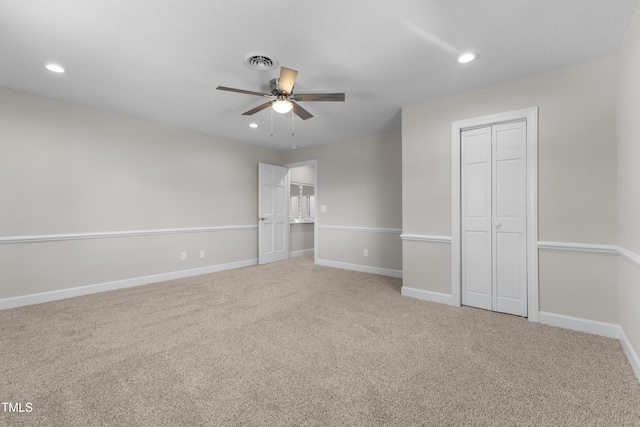 unfurnished bedroom featuring carpet floors, a closet, and ceiling fan