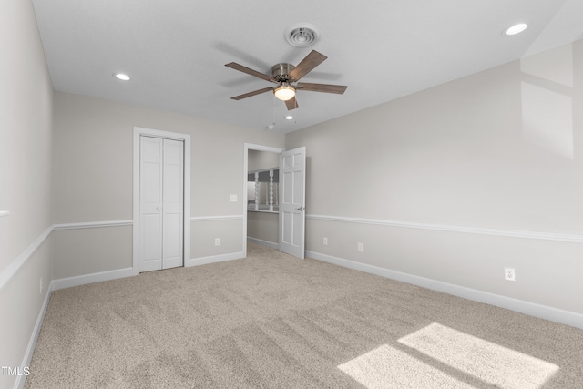 unfurnished bedroom with carpet floors, a closet, and ceiling fan