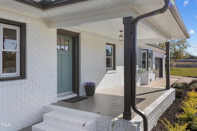 view of exterior entry with a porch