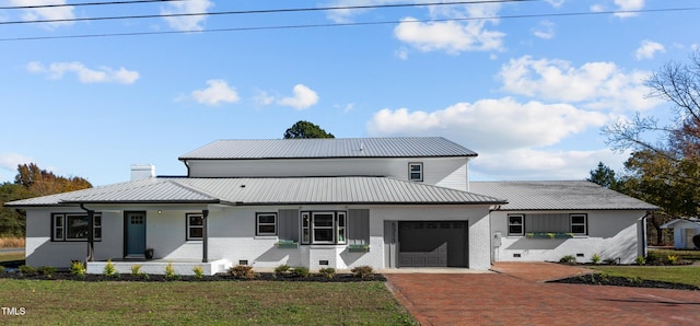 view of front of house with a porch, a garage, and a front yard