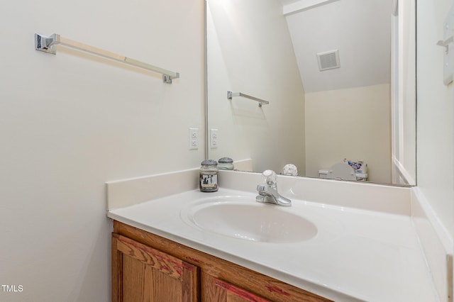 bathroom with vanity and vaulted ceiling