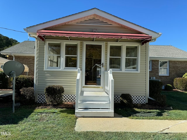 bungalow-style house with a front yard