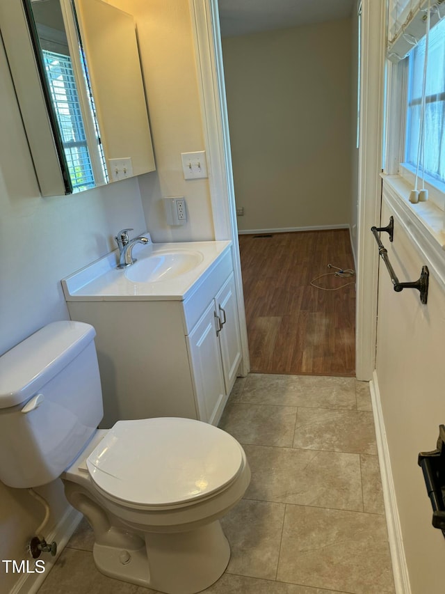 bathroom featuring hardwood / wood-style floors, vanity, and toilet