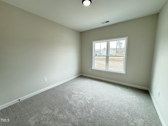 unfurnished room with carpet flooring, baseboards, and visible vents