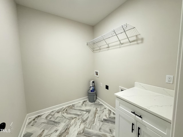 clothes washing area featuring cabinet space, hookup for an electric dryer, baseboards, and washer hookup