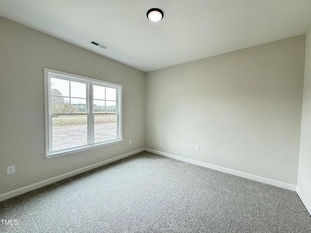 unfurnished room featuring visible vents, baseboards, and carpet flooring