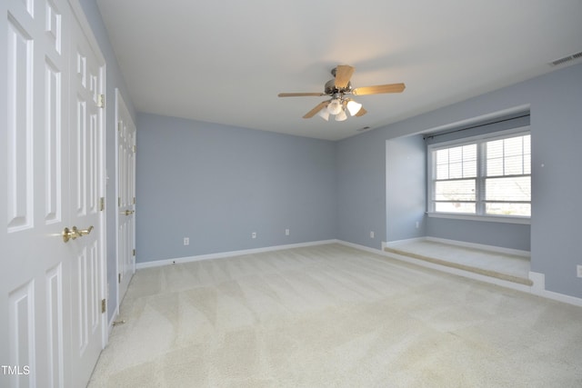 unfurnished room featuring light colored carpet and ceiling fan