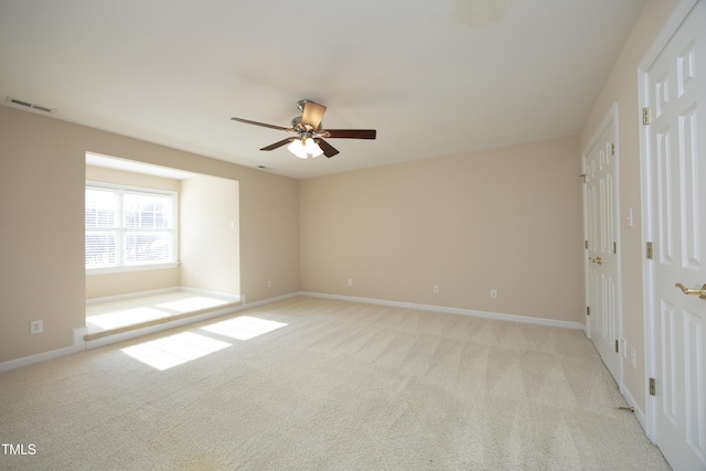 unfurnished bedroom with light colored carpet and ceiling fan