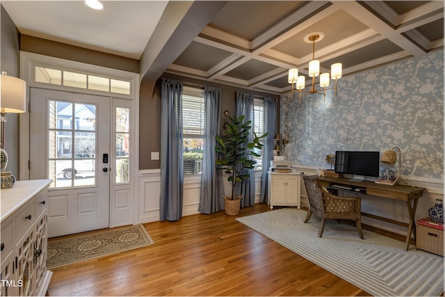 office area with beam ceiling, light hardwood / wood-style flooring, coffered ceiling, and an inviting chandelier