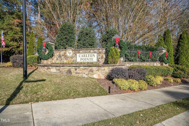 community / neighborhood sign with a lawn