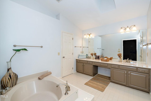 bathroom featuring vanity, vaulted ceiling, and a bathing tub