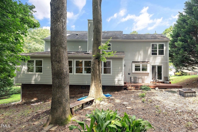 back of property featuring a wooden deck