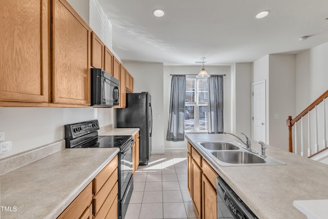 kitchen featuring pendant lighting, sink, light tile patterned floors, and black appliances