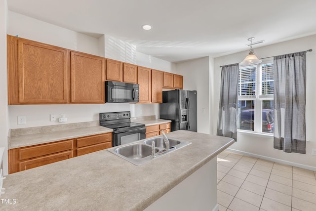 kitchen featuring hanging light fixtures, light tile patterned flooring, black appliances, and sink