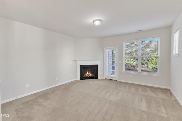 unfurnished living room featuring light colored carpet