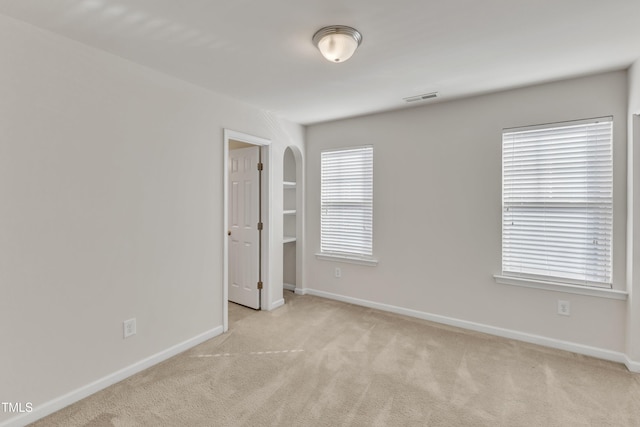 carpeted empty room with a healthy amount of sunlight