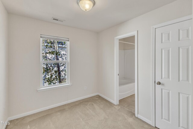 unfurnished bedroom with light carpet