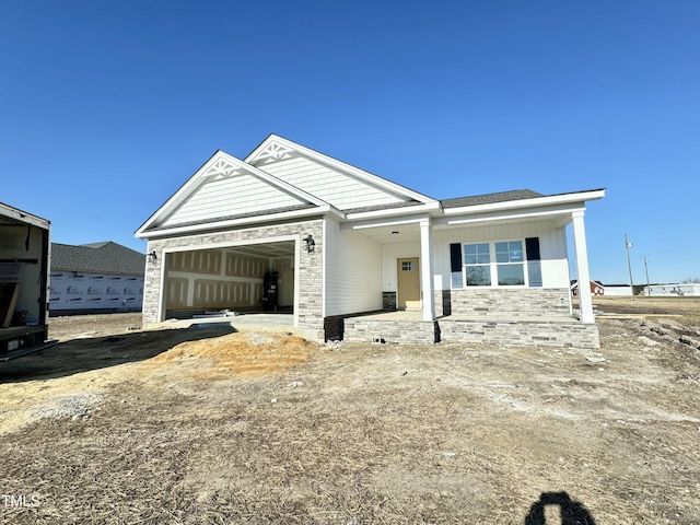 view of front of home featuring a garage and a porch