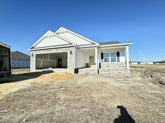 view of front facade featuring a porch and a garage