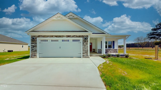 1407 Stoney Creek Church Rd, Goldsboro, NC 27534 - craftsman inspired home with covered porch, stone siding, a front yard, concrete driveway, and a garage