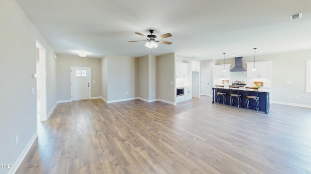 1407 Stoney Creek Church Rd, Goldsboro, NC 27534 - unfurnished living room with light wood finished floors, baseboards, ceiling fan, and recessed lighting
