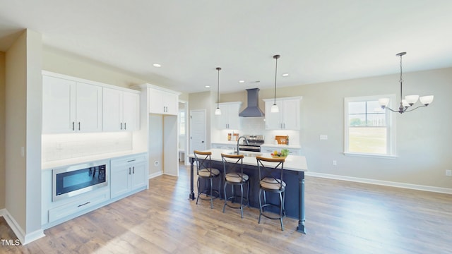 1407 Stoney Creek Church Rd, Goldsboro, NC 27534 - kitchen with wall chimney exhaust hood, appliances with stainless steel finishes, tasteful backsplash, light wood-style floors, and recessed lighting
