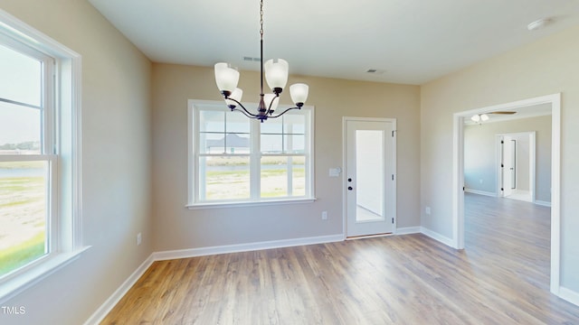1407 Stoney Creek Church Rd, Goldsboro, NC 27534 - unfurnished dining area with a chandelier, light wood-style floors, and baseboards