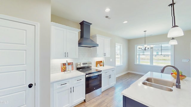 1407 Stoney Creek Church Rd, Goldsboro, NC 27534 - kitchen featuring stainless steel range with electric stovetop, a sink, wall chimney exhaust hood, tasteful backsplash, and white cabinetry