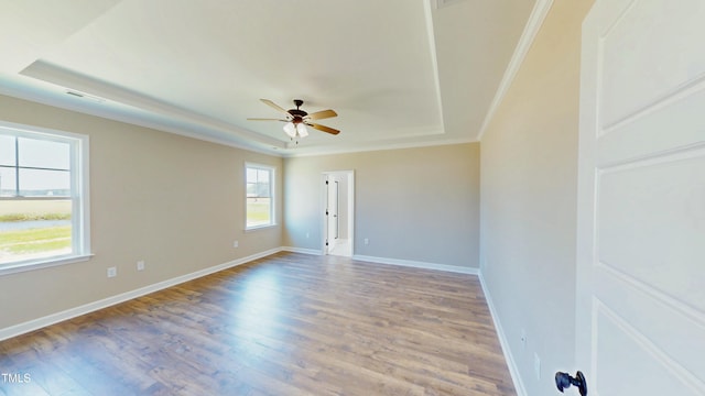 1407 Stoney Creek Church Rd, Goldsboro, NC 27534 - empty room featuring a raised ceiling, ceiling fan, ornamental molding, wood finished floors, and baseboards