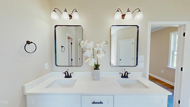 1407 Stoney Creek Church Rd, Goldsboro, NC 27534 - full bathroom with double vanity, wood finished floors, and baseboards