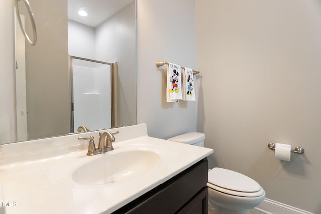 bathroom with vanity, an enclosed shower, and toilet