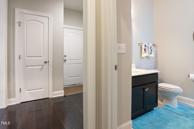 bathroom with vanity, wood-type flooring, and toilet