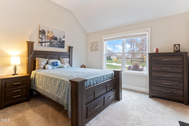 bedroom with vaulted ceiling and light colored carpet